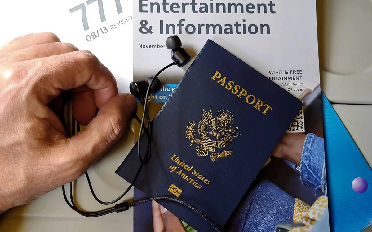 A passport and work visa documents on a desk.