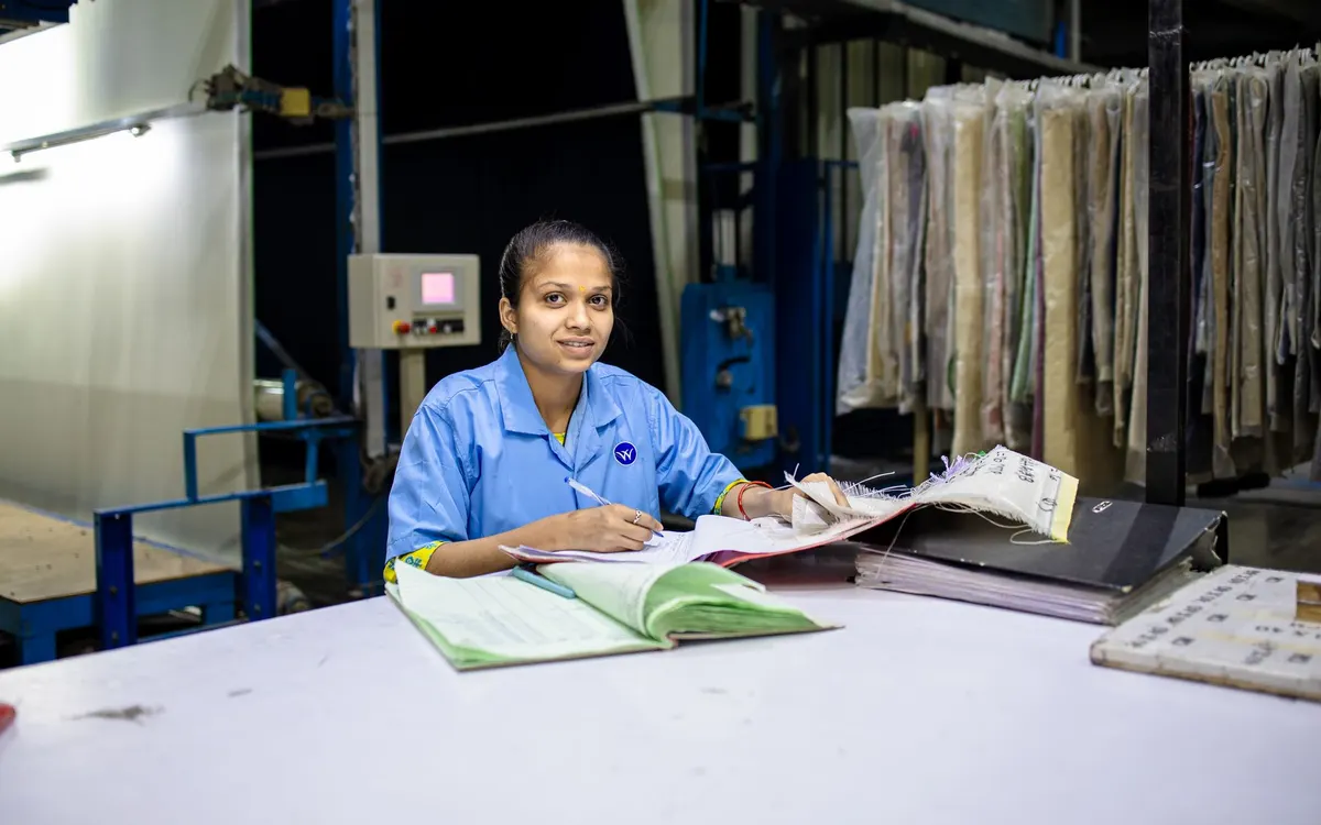 A professional reviewing classification paperwork at a desk.