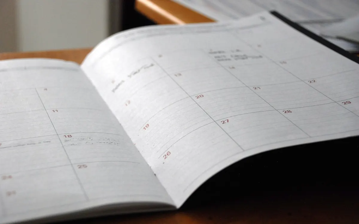 A calendar and planner on a desk.