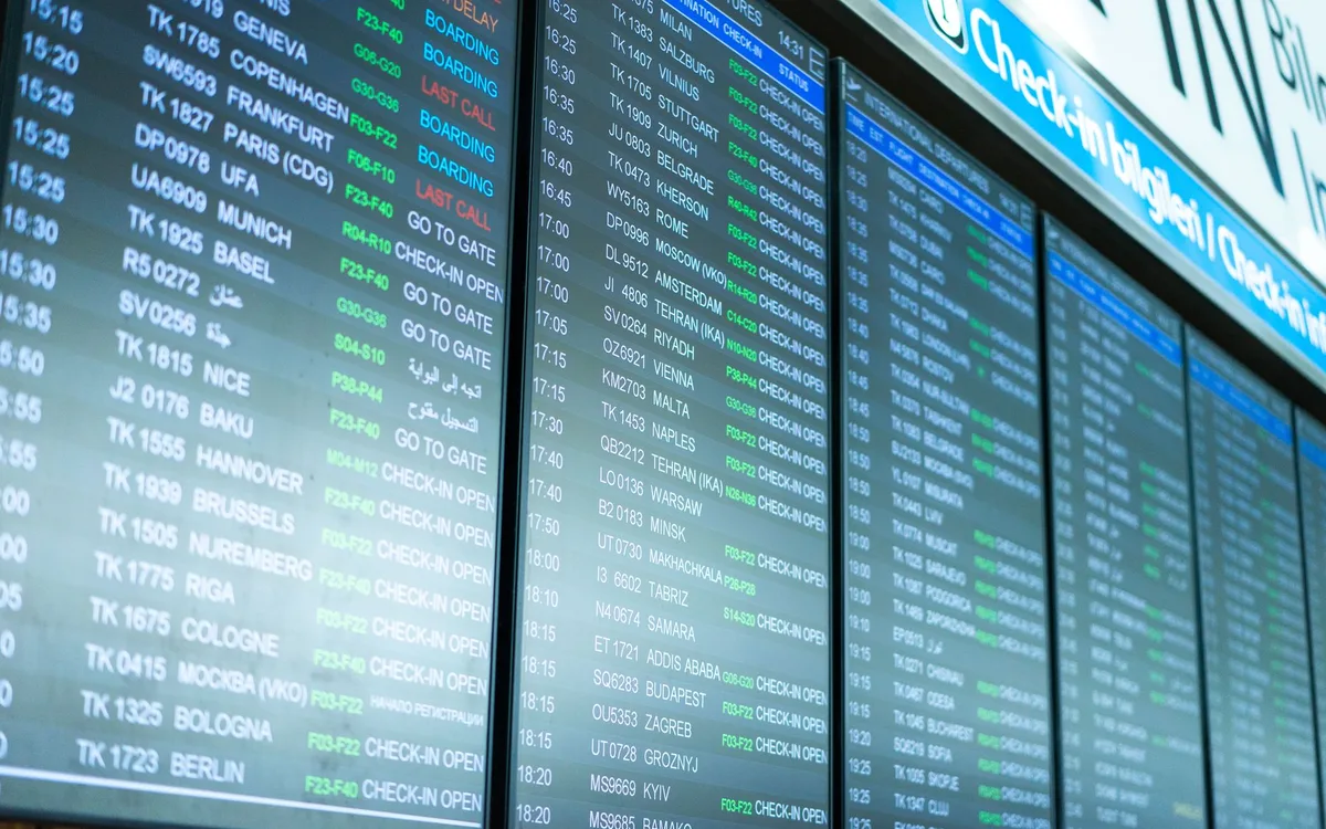 Departure board in an international airport terminal