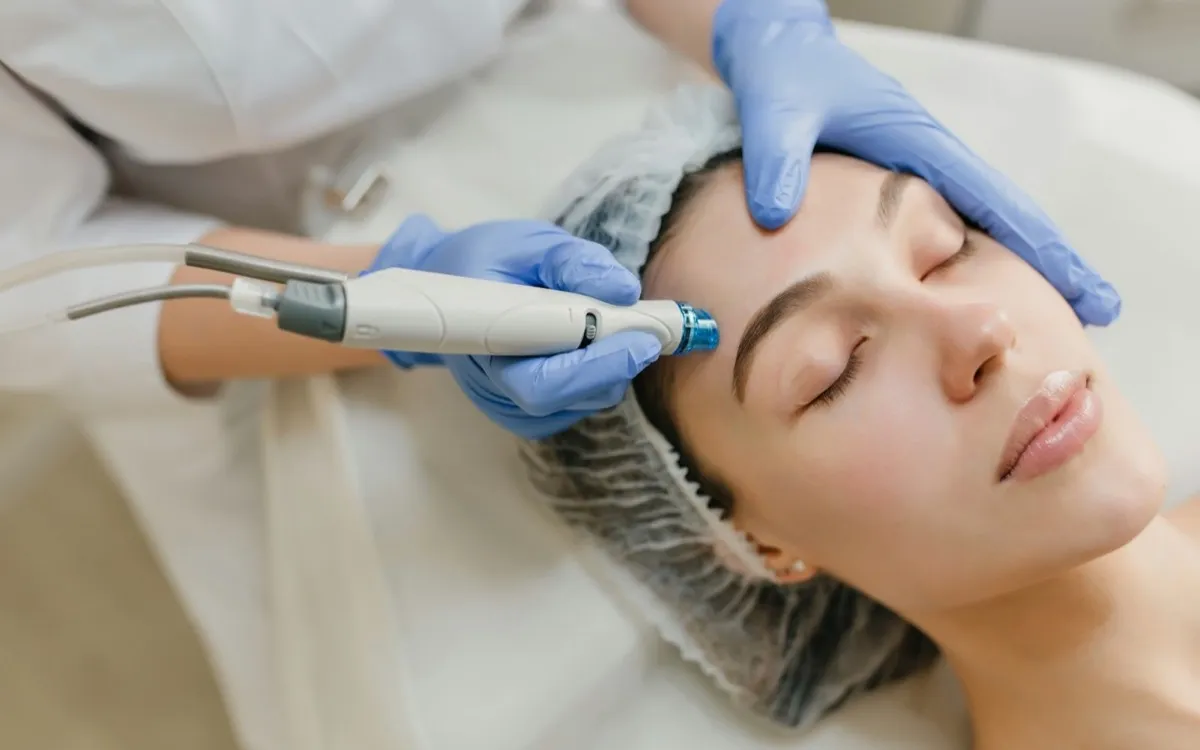Beauty therapist performing a facial treatment on a client