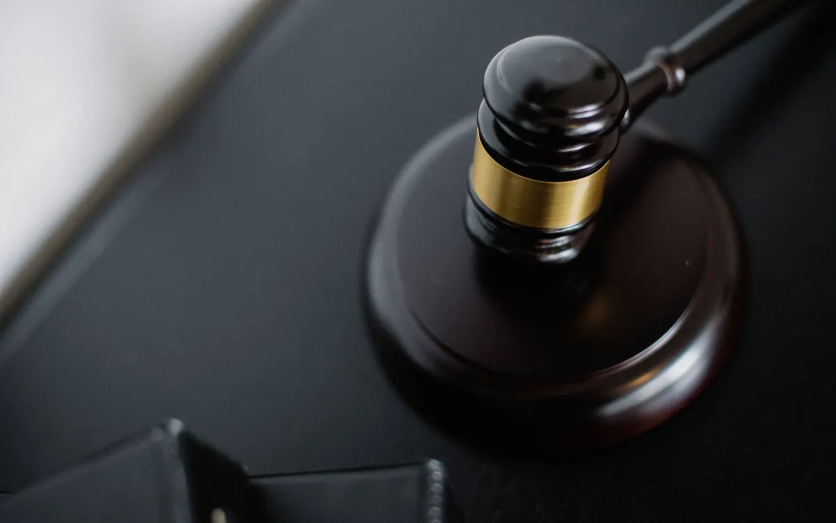 A gavel on a wooden desk.