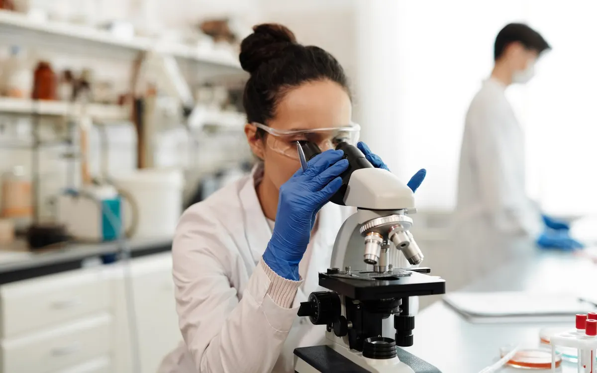 A medical laboratory technician at a microscope.
