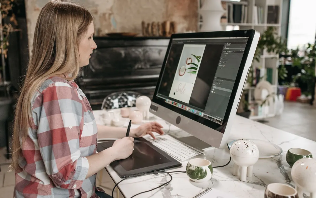 A multimedia specialist working at a computer.