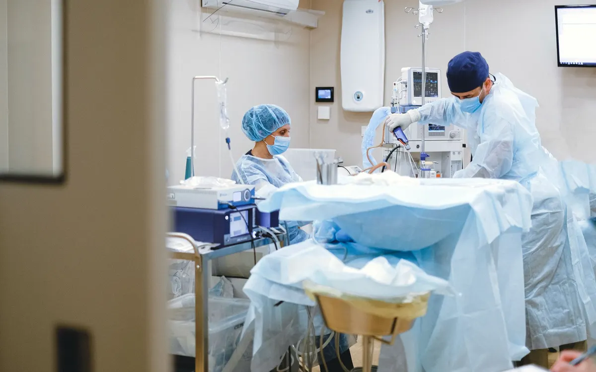 Surgeons performing an operation in a theatre.