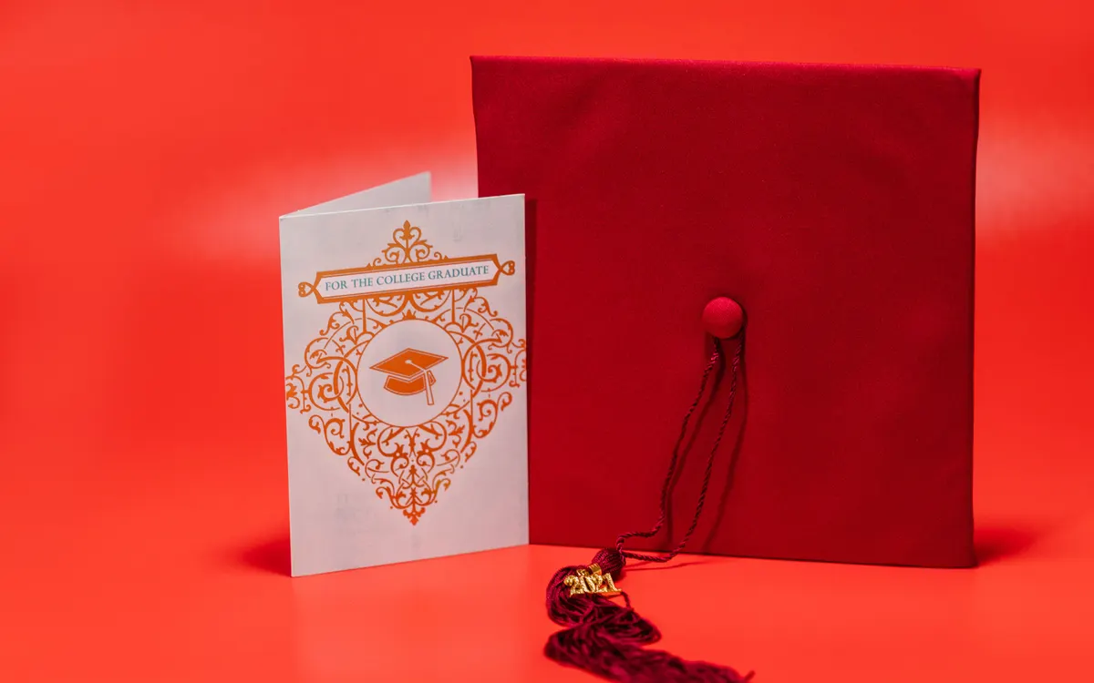 A graduation cap and graduation card.