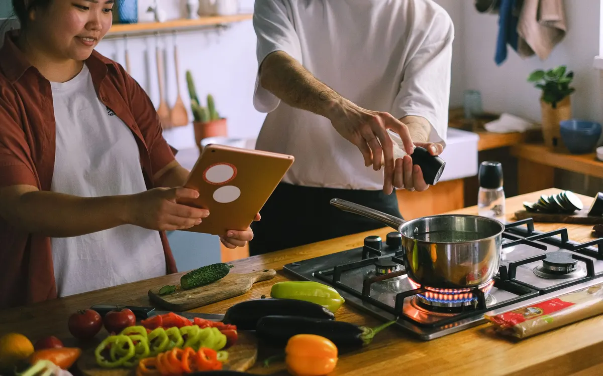 A couple cooking together at home.