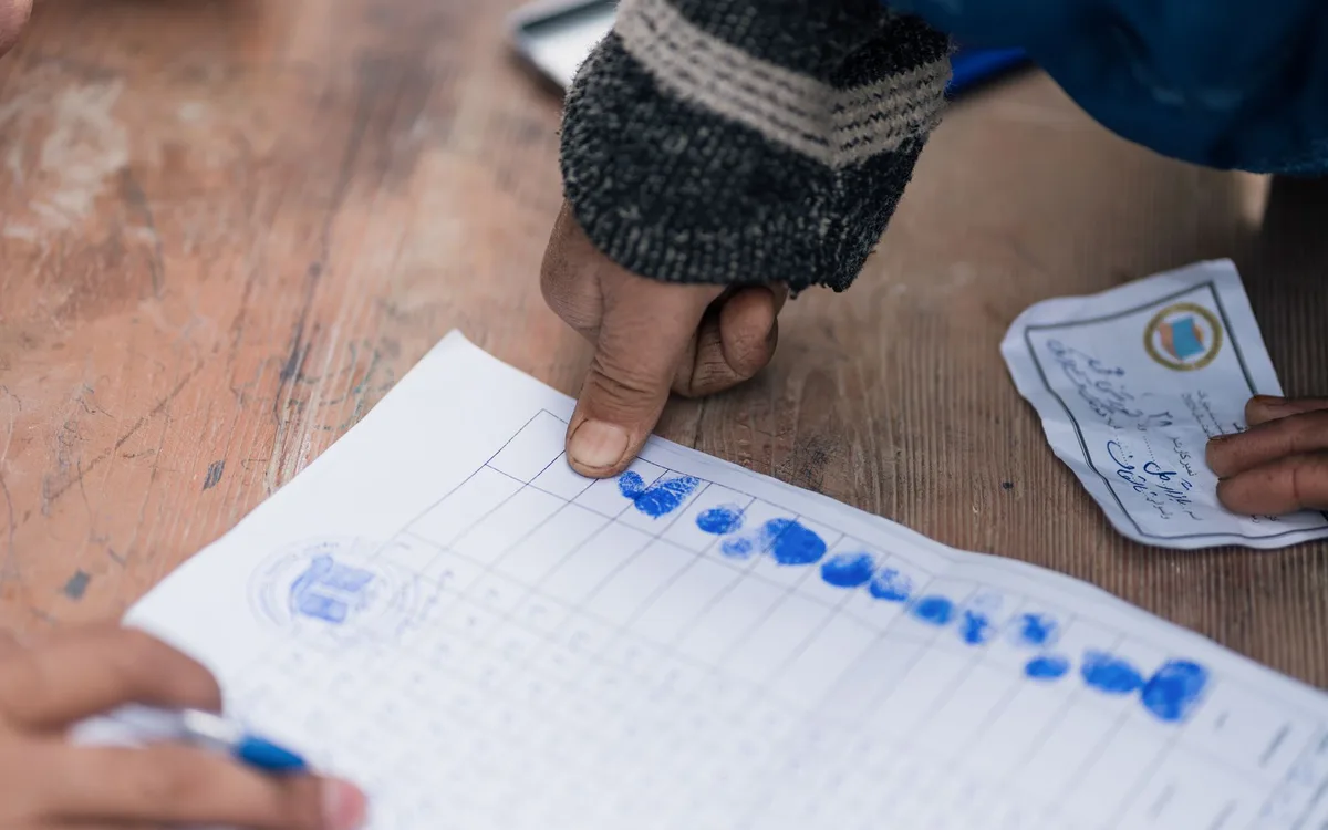 Fingerprints being recorded in ink on a paper form