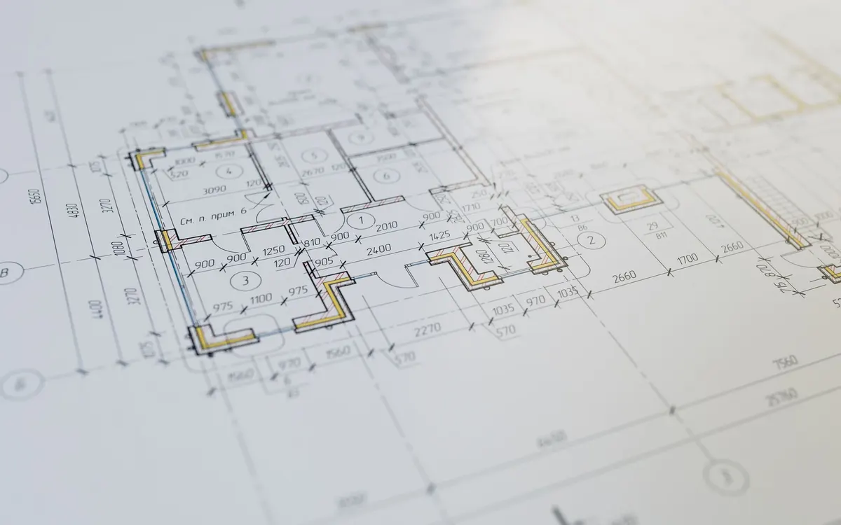 A quantity surveyor reviewing construction plans.