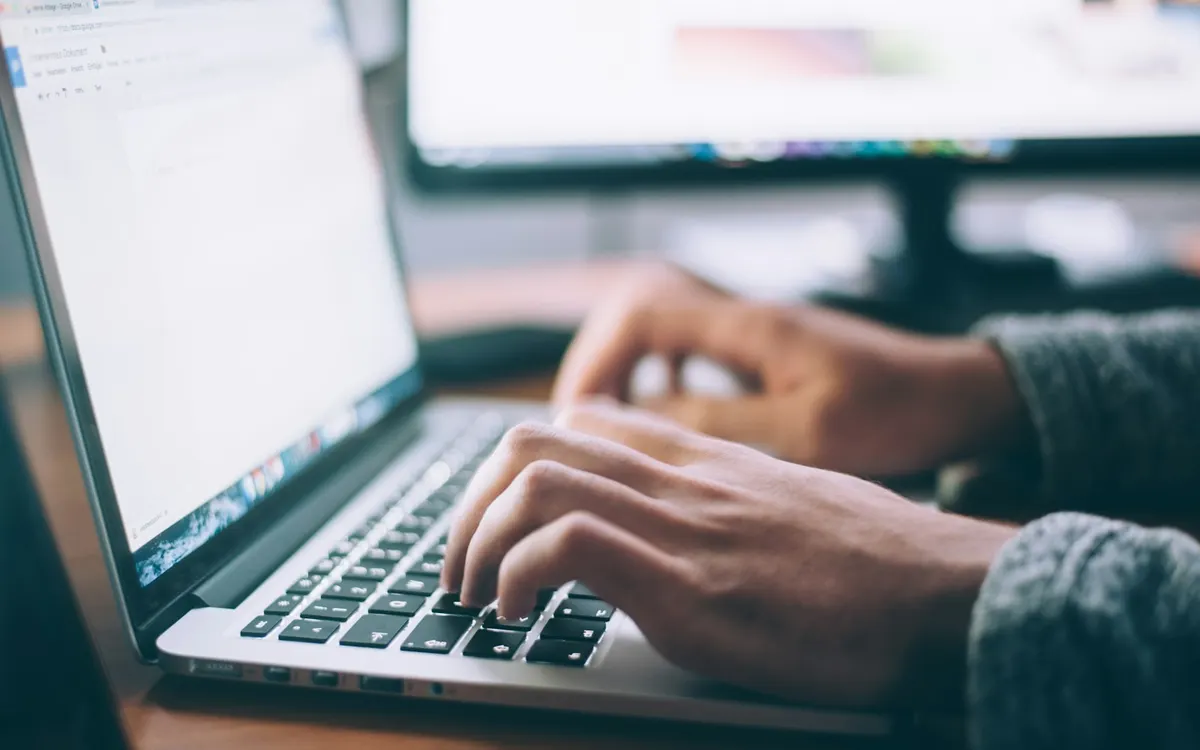 Filling in an online form on a laptop.