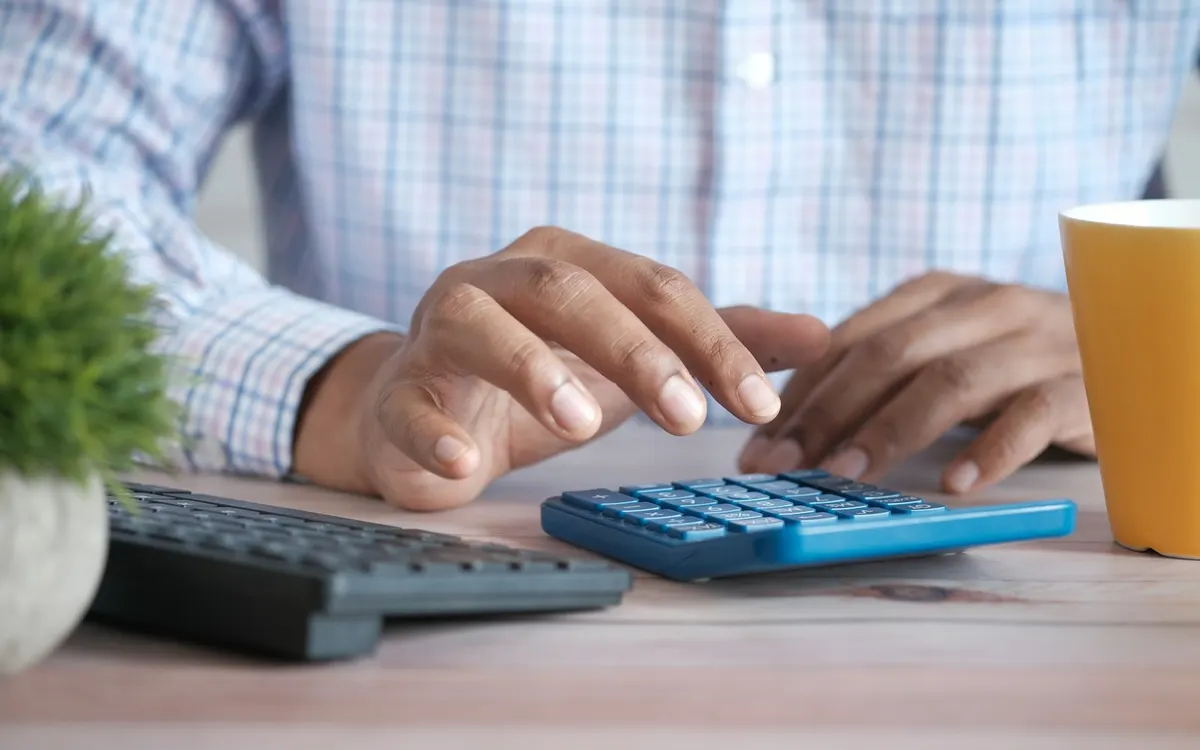 Working through numbers at a desk.