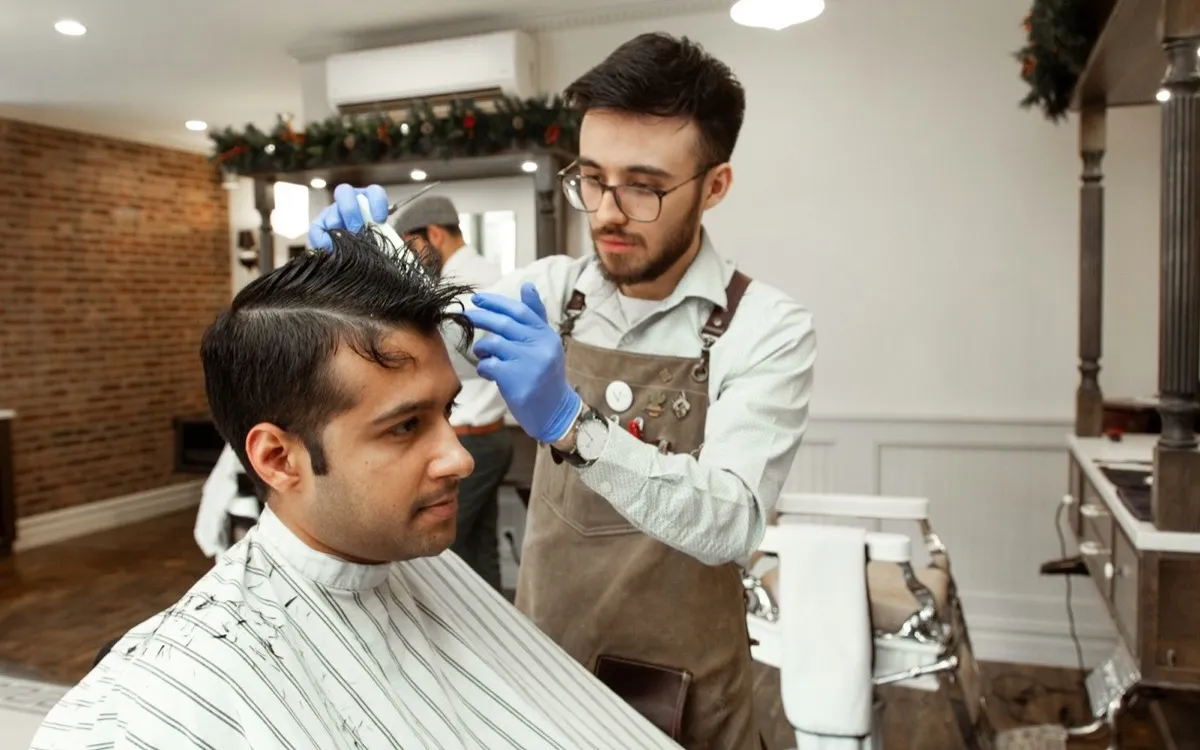Hairdresser cutting a client's hair in a salon