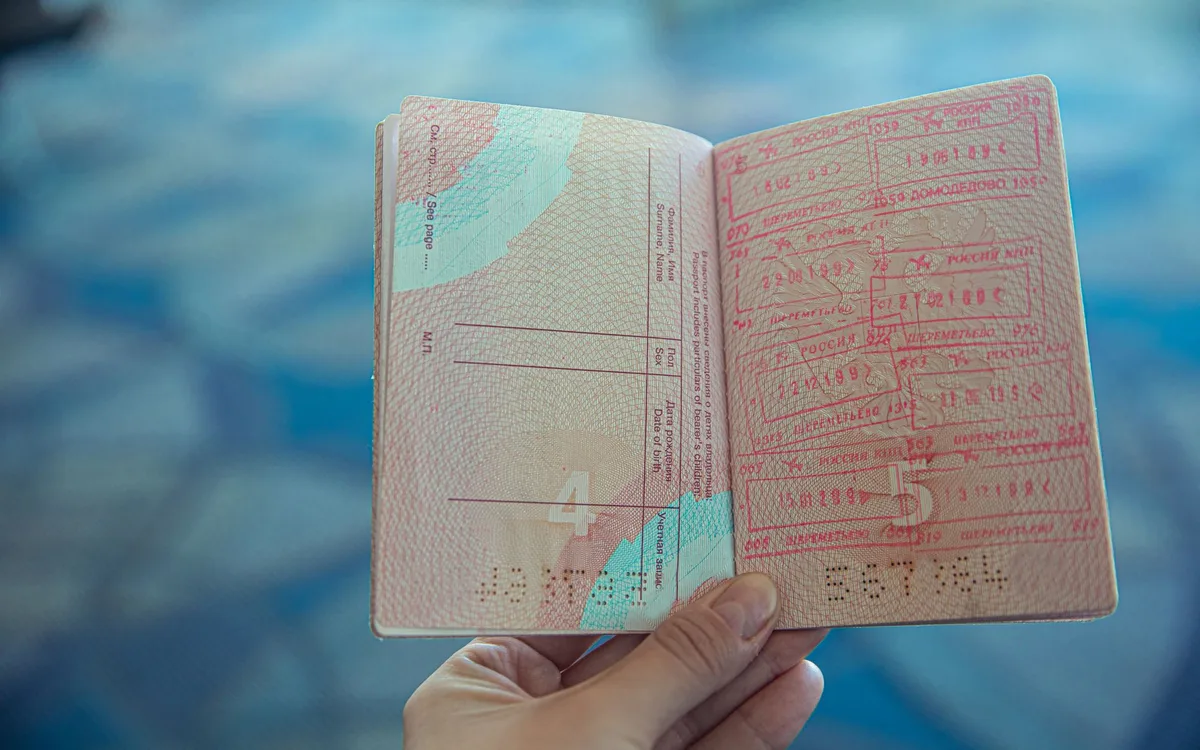 An open passport showing pages of immigration visa stamps