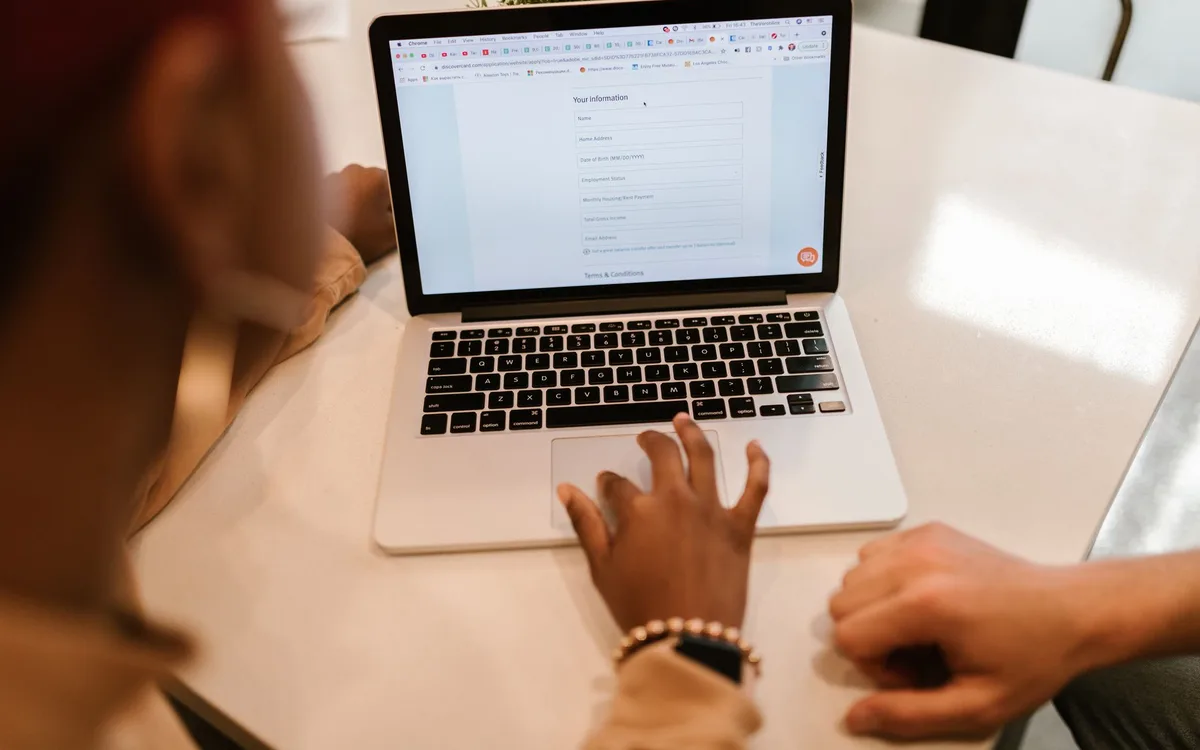 A person filling in an online form on a laptop