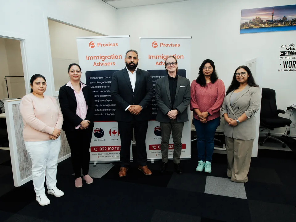 Provisas team at the Manukau office, with workspace and branded materials supporting AEWV-accredited employers.
