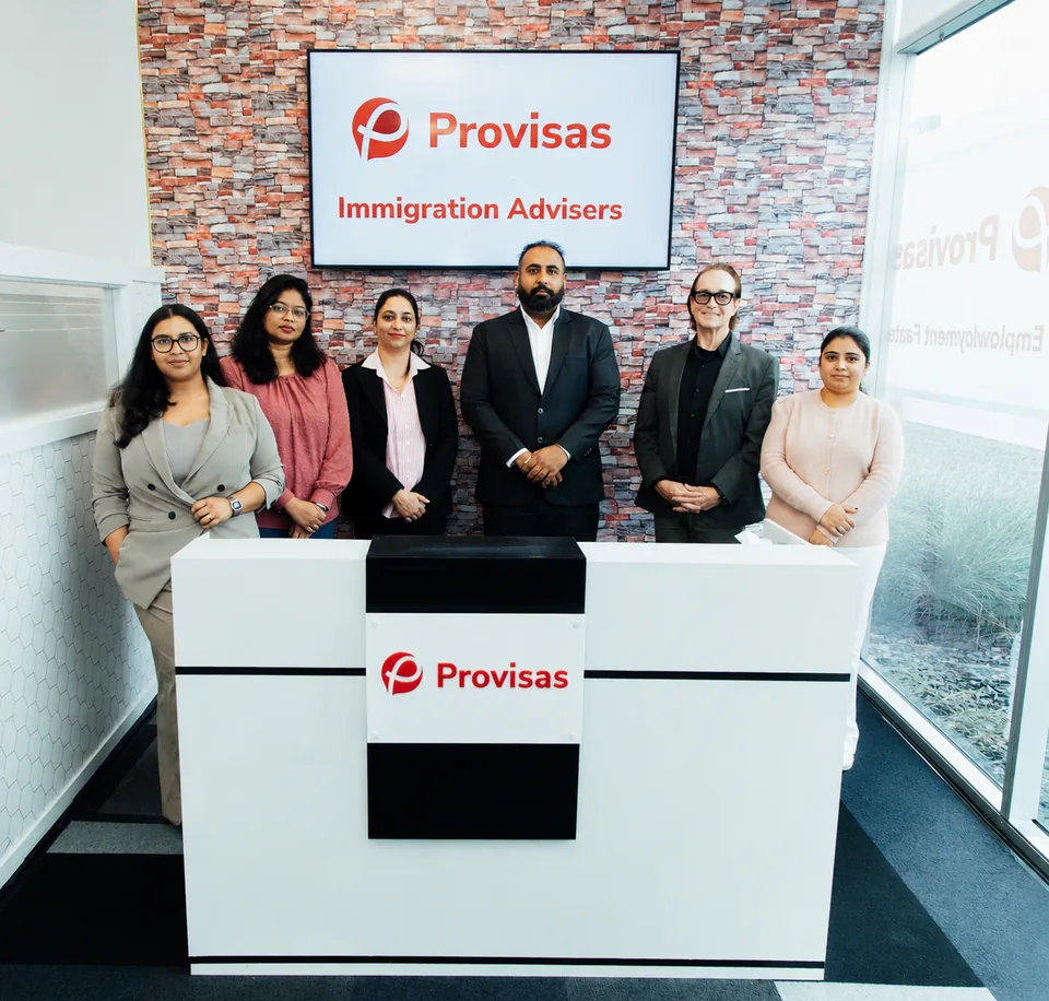 The ProVisas team of licensed immigration advisers and support staff, photographed together at the firm's reception.